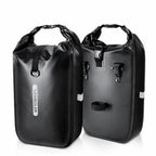 Deux sacoches de porte-bagages vélo cylindriques noires côte à côte sur fond blanc