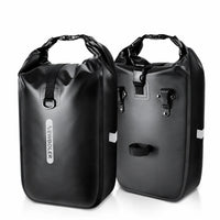 Deux sacoches de porte-bagages vélo cylindriques noires côte à côte sur fond blanc