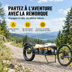 Remorque vélo attelée à l'arrière d'un vélo sur un chemin de gravier, bac chargé d'une tente et de sacs