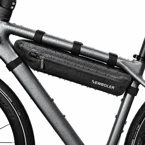 Sacoche triangulaire noire installee sur le cadre d'un velo, vue rapprochee avec fixations sangles.