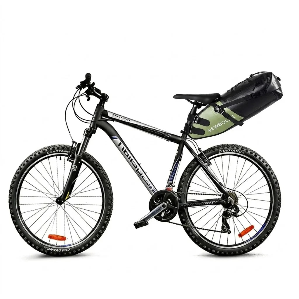 Sacoche de selle noire et verte installée sous la selle d'un VTT noir, vue d'ensemble du vélo sur fond blanc.