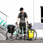 Cycliste debout à côté d'un vélo équipé de la sacoche 27L sur le porte-bagage